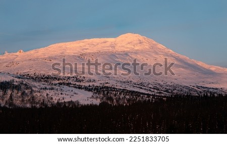 Amazing view over the Scandinavian mountain ranges. Snowy vallyes between massive mountains. Winter wonderland with an amazing sunset. View from the top of Are ski resort