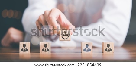HRM or Human Resource Management ,Strategic planning for success through people business development concept by choosing professional leaders employee competency Teamwork, man holding a wooden block Royalty-Free Stock Photo #2251854699