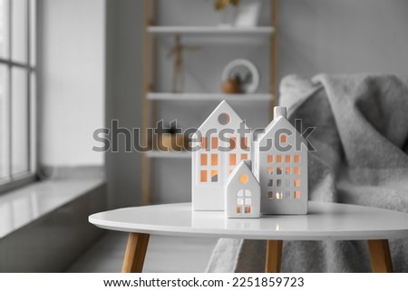 House candle holders on table in light living room, closeup Royalty-Free Stock Photo #2251859723