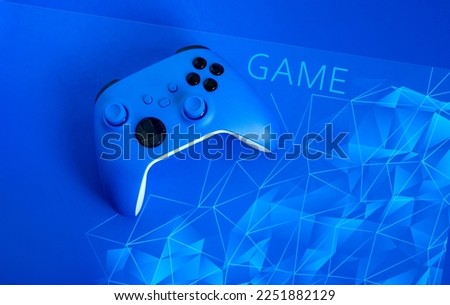 Banner blue background with blue gamepad, Testk "Game". Game concept, esports, leisure, gaming industry, video games. Flat lay, top view