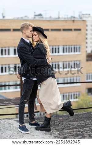 Beautiful happy young loving couple on a surprise date on a Saint Valentine's Day. Romantic modern wedding on the rooftop, summertime. Young man and beautiful girl. Newlyweds on honeymoon boho style