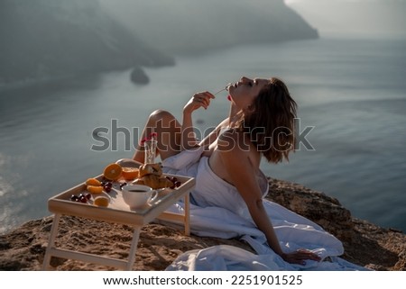 Woman wake up in bed wuth duvet and pillow over nature sea background outdoors. Back view. Good morning. Freedom concept.
