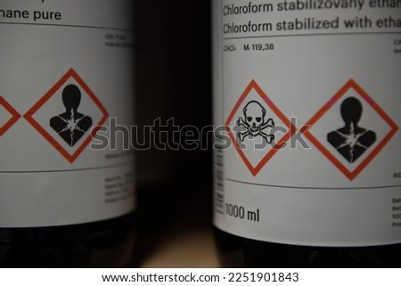 Red ghs pictograms on a bottles of organic solvents.