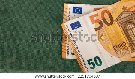 Closeup of fifty euro currency note on green table with copy space.