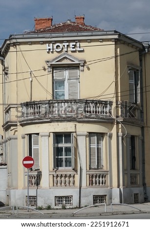 Old hotel. Stip, Macedonia. Red traffic sign. Yellow facade.