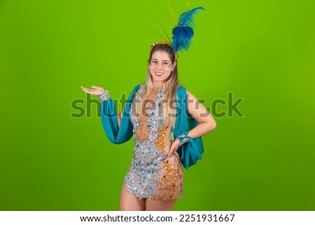 Brazilian Dressed Samba Costume. Beautiful samba dancer with blue dress ready for carnival pointing to free space for text