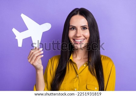 Photo of lovely adorable lady hold paper plane recommend travel agency isolated on purple color background