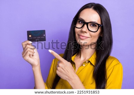 Photo of adorable lovely lady wear stylish clothes arm demonstrate plastic debit card recommend use isolated on purple color background