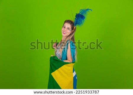 Brazilian woman posing in samba costume on green background with the flag of Brazil