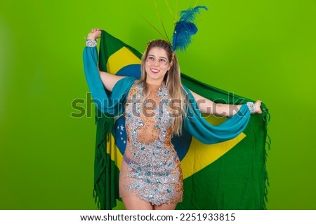 Brazilian woman posing in samba costume on green background with the flag of Brazil