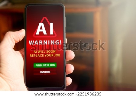 Horizontal shot of male hand holding mobile phone screen with warning about AI replacing the man's job soon in the future. Concept of AI replacing jobs, social issue. Royalty-Free Stock Photo #2251936205