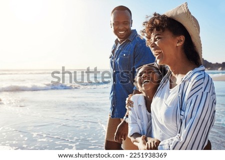 Family, travel and walking on a beach with adorable child on vacation or holiday at the ocean or sea. Summer, mother and father with black kid or daughter holding hands together near water Royalty-Free Stock Photo #2251938369