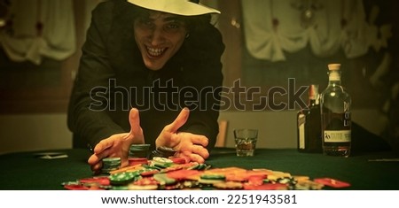 A dramatic moment in a high-stakes poker game as all the chips, or "fiches," are pushed forward, signaling an all-in bet. Representing the high stakes and the potential for a big payout. Royalty-Free Stock Photo #2251943581