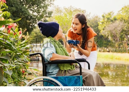Asian family, grateful daughter takes care of mother who is sick and disabled with paralysis, feeds her food to restore her body and keep her healthy : Elderly insurance health care concept Royalty-Free Stock Photo #2251946433
