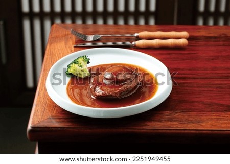 Braised abalone with broccoli and bean curd, premium expensive Chinese delicacy served during dinner celebrations Royalty-Free Stock Photo #2251949455