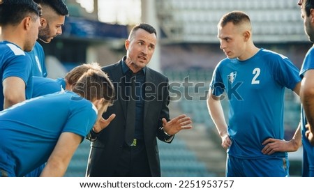Professional Soccer Team Training, Tactical Coaching: Football Coach Explains Game Strategy, Tactics, Workout Plan to Players. Trainer Motivates Athletes, Leads to Victory, Preparing For Championship Royalty-Free Stock Photo #2251953757