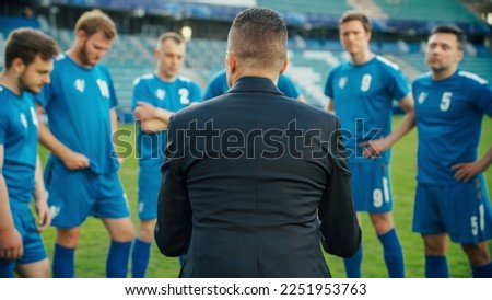 Professional Soccer Team Training, Tactical Coaching: Football Coach Explains Game Strategy, Develop Workout Plan Trainer Motivates Athletes, Leads to Victory, Preparing For Championship. Back View Royalty-Free Stock Photo #2251953763
