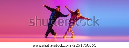 Synchronized movements. Young expressive hip-hop dancers dancing in neon. Concept of dance, youth, hobby, dynamics, movement, action, ad. Banner with copy space Royalty-Free Stock Photo #2251960851