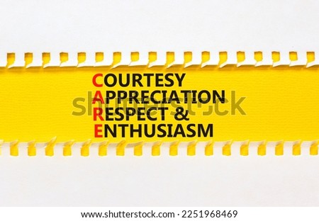 CARE symbol. Concept words CARE courtesy appreciation respect and enthusiasm on yellow paper on beautiful white background. Business CARE courtesy appreciation respect enthusiasm concept. Copy space.