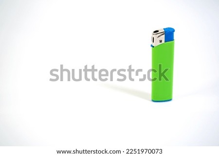 Green and blue lighter macro on white background