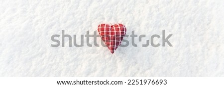 Banner image.A red heart flat lay on the snow top view, valentines day concept.White snow texture background.Copy space.