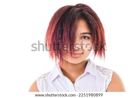 A portrait of beautiful American teen over studio background having beautiful hair
