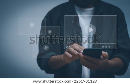 concept of video streaming with internet technology. Watching TV online, users watch movies with their mobile phones on the virtual screen showing a multimedia player with play buttons.