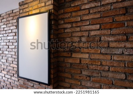 Mock up poster on brick wall. Template display for your adverting or branding in loft style interior.