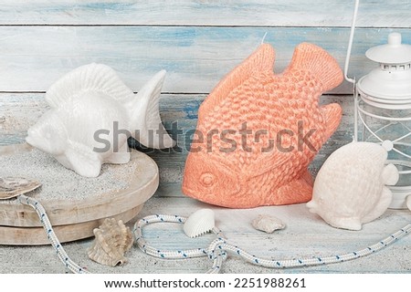 Colored and scented candle of various shapes on wooden background. ideal gift for Christmas, Easter, Valentine's Day. Eggs, sea, heart, flower, fish, starfish, seashell, coral