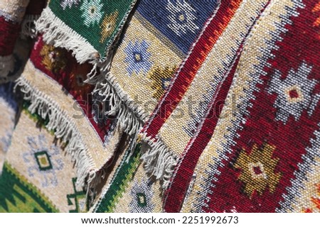 Colorful woolen rugs with traditional oriental ornaments. Close up photo with soft selective focus taken at the marketplace of Tbilisi, Georgia
