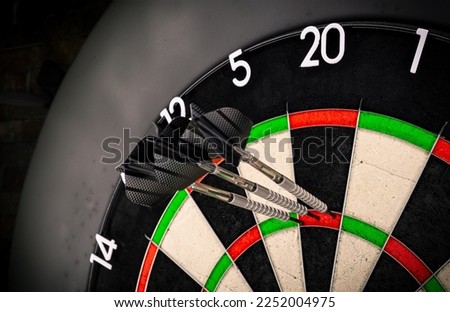 Three darts in triple twenty on professional sisal steeldart. perfect 180 highscore shot dart game hobby sport concept background. Royalty-Free Stock Photo #2252004975