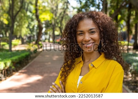 Portrait of smiling Brazilian woman looking at the camera  Royalty-Free Stock Photo #2252013587