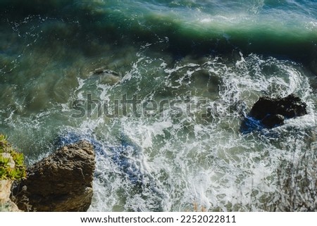 Background. The texture of the ocean. Top view of sea waves, water, sea foam
