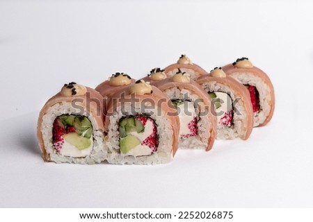 beautifully prepared sushi with philadelphia cheese on a white background.