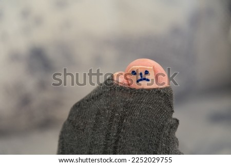 sad smiley on toe at hole in sock