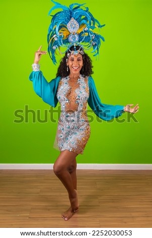 Brazilian afro woman posing in samba costume over green background with free space 