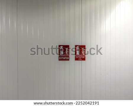 Wall with fire extinguisher symbols