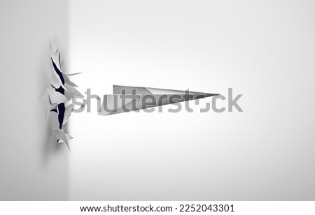 Breaking through and overcoming challenges or surmounting difficulties as a paper airplane blasting out of a wall as a symbol to overcome obstacles as a business success metaphor. Royalty-Free Stock Photo #2252043301