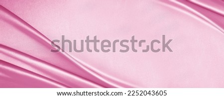 Light delicate pink silk satin fabric. Elegant background with space for design. Flat lay, table top view. Banner. Wide. Long. Panoramic. Template. For babies. Or a wedding, Valentine's Day, romance.