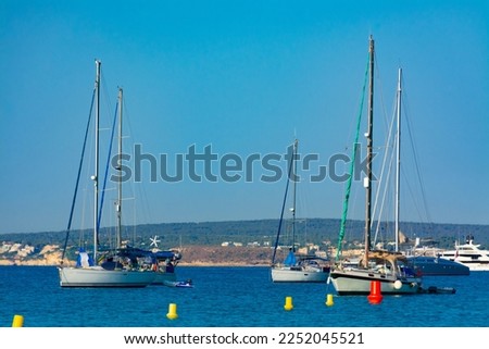 Moored boats at Cala Xinxell, in Ses Illetes, south of the city of Palma, with Palmanova at background