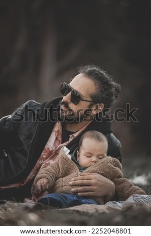 New born fall family photo shoot in forest with rad dad wearing sunglasses￼ and man bun