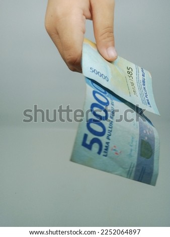 Close-up of a folded banknote in hand