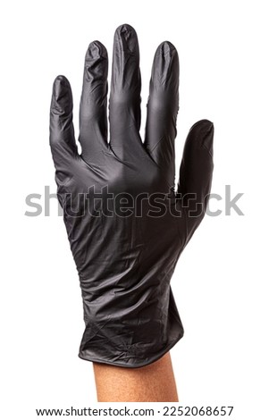 Hand in black rubber glove isolated on white background. Raised up hand as a symbol of agreement or support, closeup