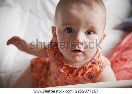Six months old baby with orange cloth Royalty-Free Stock Photo #2252077167