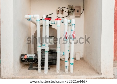 Pool pump with sand filter installed. Pool purification and maintenance system. Home pool filter and treatment plant installed Royalty-Free Stock Photo #2252164467
