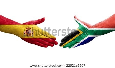 Handshake between South Africa and Spain flags painted on hands, isolated transparent image.