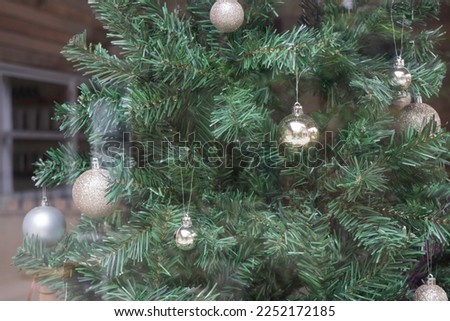 Christmas tree decor on the window of a wooden house, stock photo
