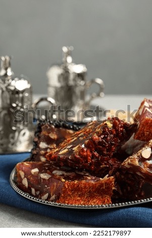 Tea and Turkish delight served in vintage tea set on grey table, closeup. Space for text