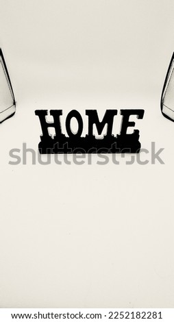 Black and white lettering. Wooden HOME.