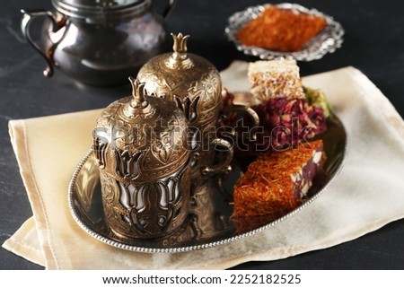 Tea and Turkish delight served in vintage tea set on dark grey textured table